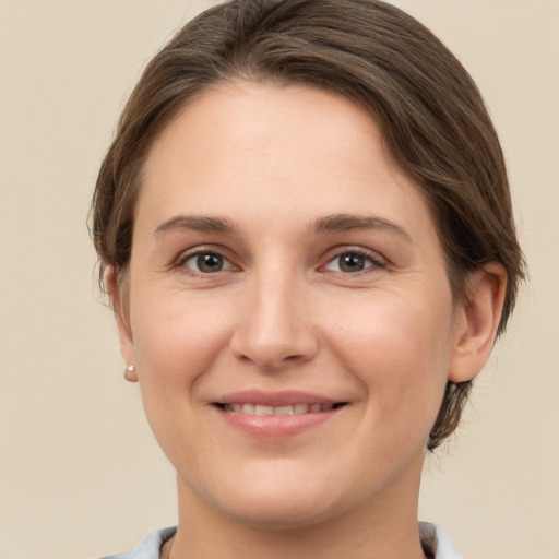 Joyful white young-adult female with short  brown hair and brown eyes