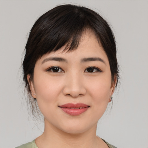 Joyful asian young-adult female with medium  brown hair and brown eyes