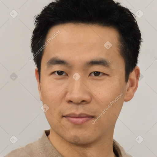 Joyful asian young-adult male with short  black hair and brown eyes