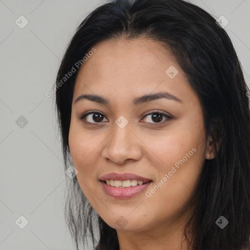 Joyful latino young-adult female with long  brown hair and brown eyes