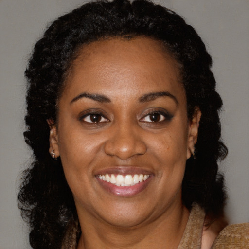 Joyful black young-adult female with medium  black hair and brown eyes