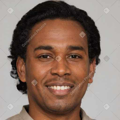 Joyful black young-adult male with short  black hair and brown eyes