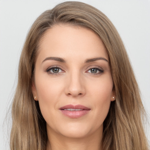 Joyful white young-adult female with long  brown hair and brown eyes