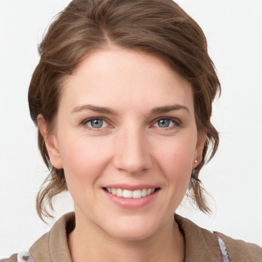 Joyful white young-adult female with medium  brown hair and grey eyes