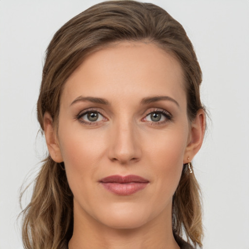 Joyful white young-adult female with long  brown hair and grey eyes