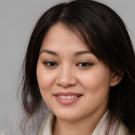 Joyful asian young-adult female with long  brown hair and brown eyes