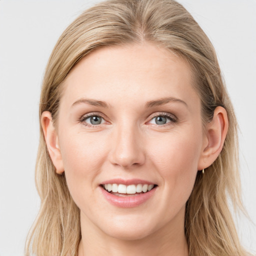 Joyful white young-adult female with long  brown hair and blue eyes