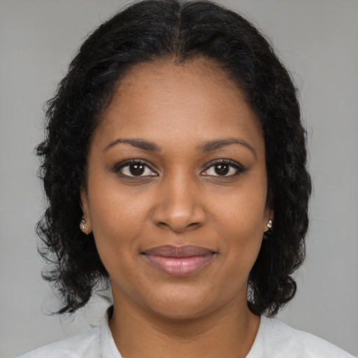 Joyful black young-adult female with medium  brown hair and brown eyes