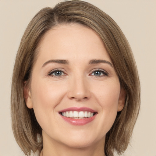 Joyful white young-adult female with medium  brown hair and green eyes