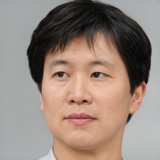 Neutral asian adult male with short  brown hair and brown eyes