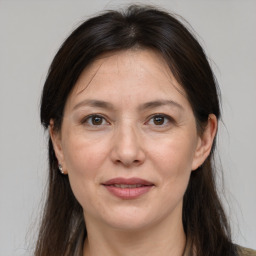 Joyful white adult female with medium  brown hair and grey eyes