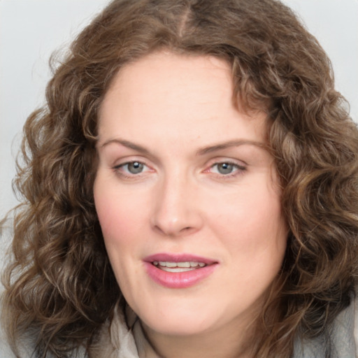 Joyful white young-adult female with medium  brown hair and green eyes