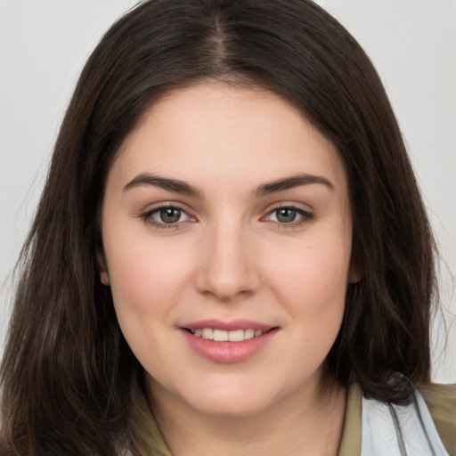 Joyful white young-adult female with long  brown hair and brown eyes