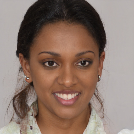 Joyful black young-adult female with medium  brown hair and brown eyes
