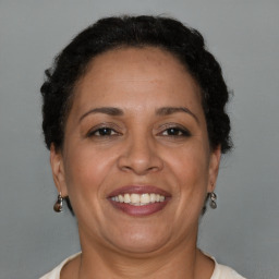 Joyful latino adult female with short  brown hair and brown eyes