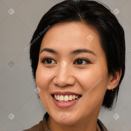 Joyful latino young-adult female with medium  brown hair and brown eyes