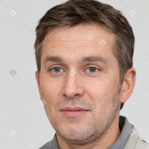 Joyful white adult male with short  brown hair and brown eyes