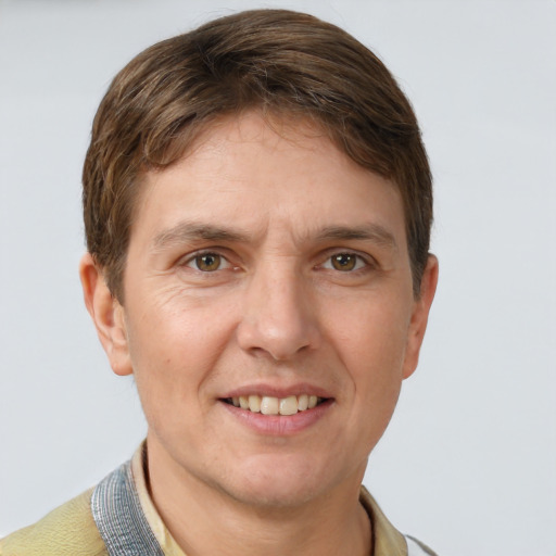 Joyful white adult male with short  brown hair and grey eyes