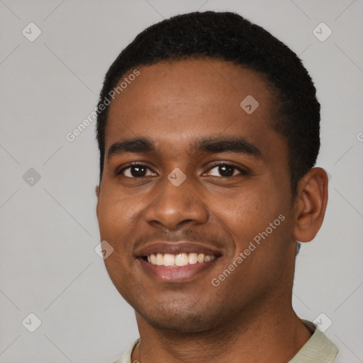 Joyful black young-adult male with short  black hair and brown eyes