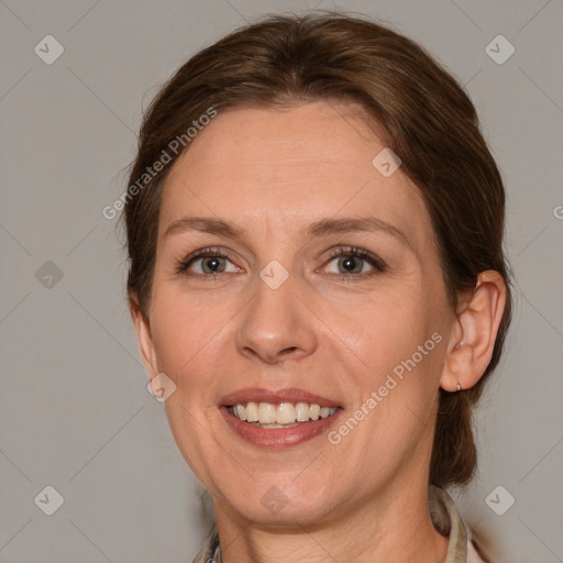 Joyful white adult female with medium  brown hair and grey eyes