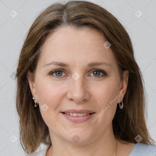 Joyful white adult female with medium  brown hair and grey eyes