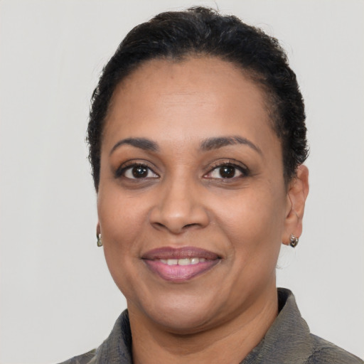 Joyful latino adult female with short  black hair and brown eyes