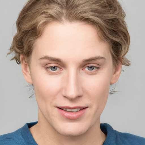 Joyful white young-adult female with medium  brown hair and blue eyes