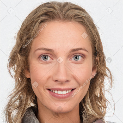 Joyful white adult female with medium  brown hair and blue eyes