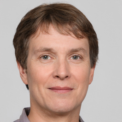 Joyful white adult male with short  brown hair and grey eyes