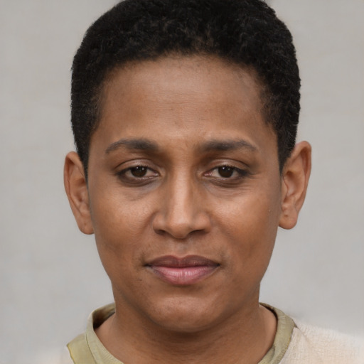 Joyful black young-adult female with short  brown hair and brown eyes