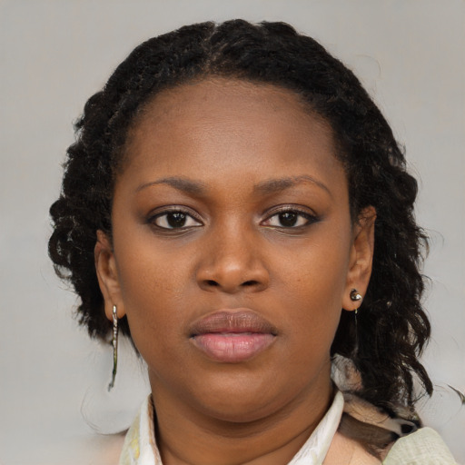 Neutral black young-adult female with medium  brown hair and brown eyes