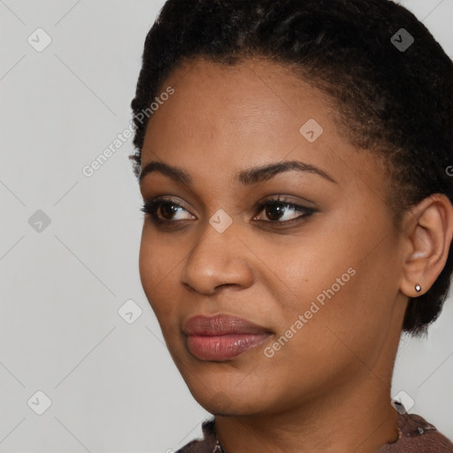 Joyful black young-adult female with short  black hair and brown eyes