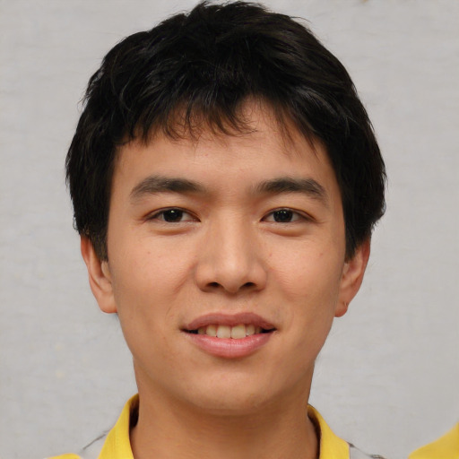 Joyful asian young-adult male with short  brown hair and brown eyes