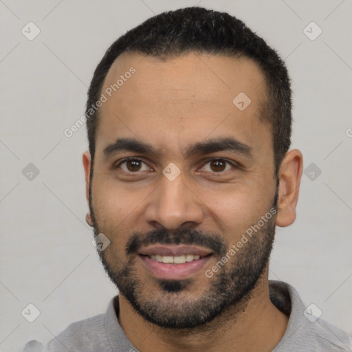 Joyful latino young-adult male with short  black hair and brown eyes