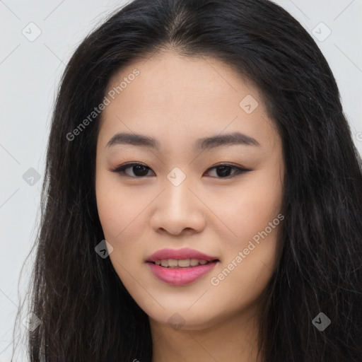 Joyful asian young-adult female with long  brown hair and brown eyes