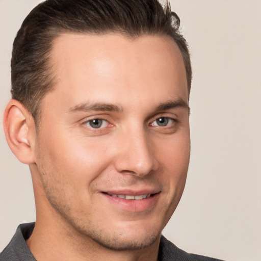 Joyful white young-adult male with short  brown hair and brown eyes