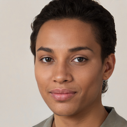 Joyful latino young-adult female with short  brown hair and brown eyes