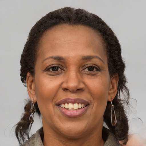 Joyful latino adult female with medium  brown hair and brown eyes