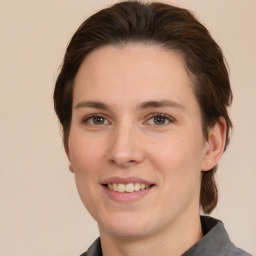 Joyful white young-adult female with medium  brown hair and brown eyes