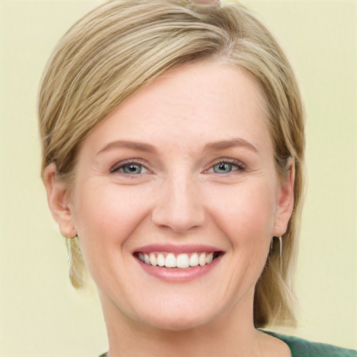 Joyful white young-adult female with medium  brown hair and green eyes