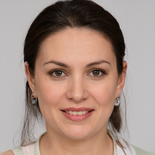 Joyful white young-adult female with medium  brown hair and brown eyes