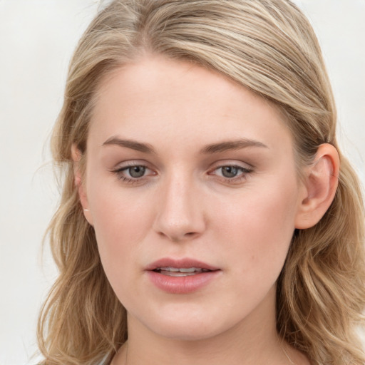 Joyful white young-adult female with long  brown hair and blue eyes