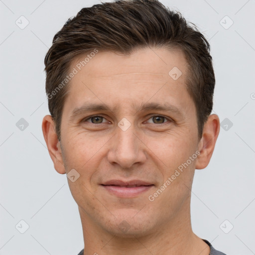 Joyful white adult male with short  brown hair and brown eyes