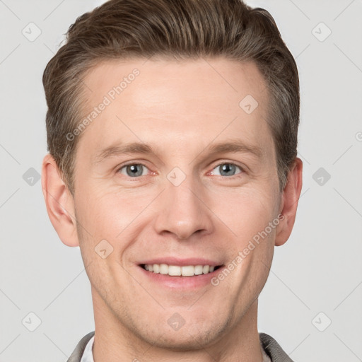 Joyful white young-adult male with short  brown hair and grey eyes