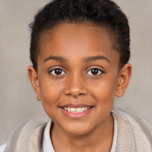 Joyful black child female with short  brown hair and brown eyes