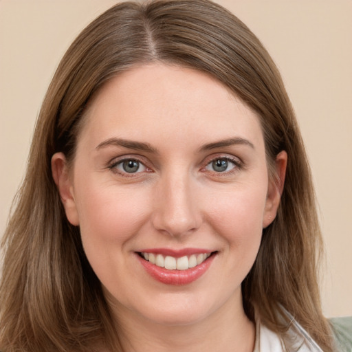 Joyful white young-adult female with medium  brown hair and grey eyes