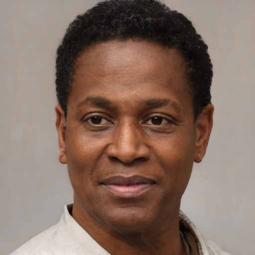 Joyful black adult male with short  black hair and brown eyes