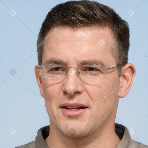 Joyful white adult male with short  brown hair and grey eyes