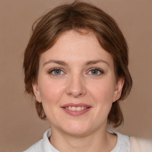 Joyful white young-adult female with medium  brown hair and blue eyes