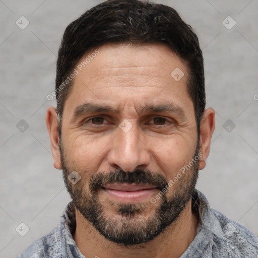 Joyful white adult male with short  black hair and brown eyes